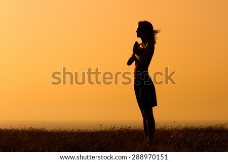 Silhouette of a woman meditating.Peace of mind