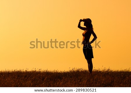 Happy woman enjoys in sunset.Peace of mind in nature