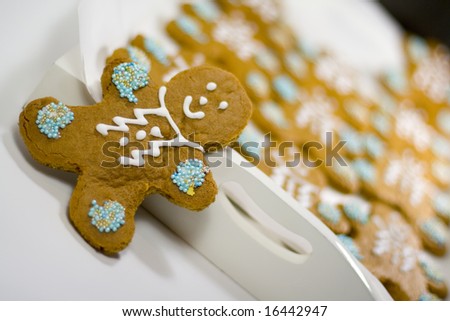 closeup of fresh baked cheerful gingerbread men cookies with decorations
