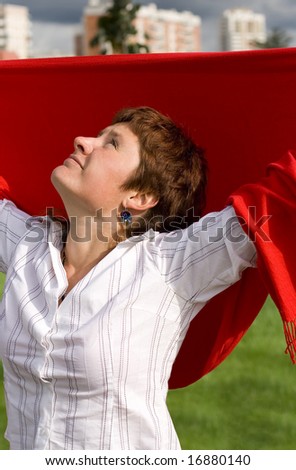 outdoor portrait of redhead woman with red scarf