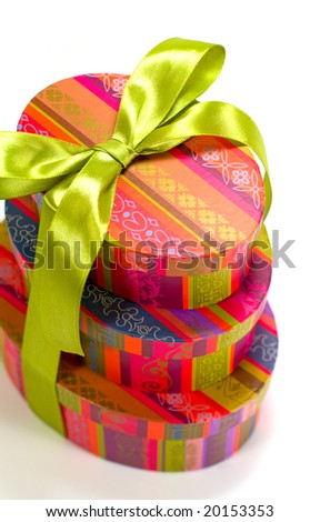 pyramid of colorful gift boxes with green bow on white background