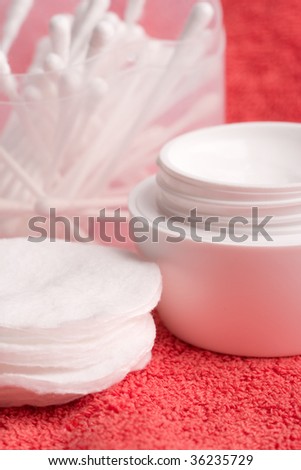 closeup of facial cream and cotton pads - cosmetics