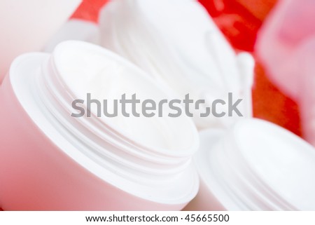closeup of facial cream and cotton pads - cosmetics