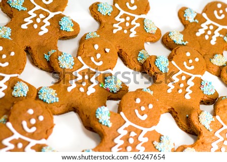 fresh baked gingerbread men cookies with decorations closeup