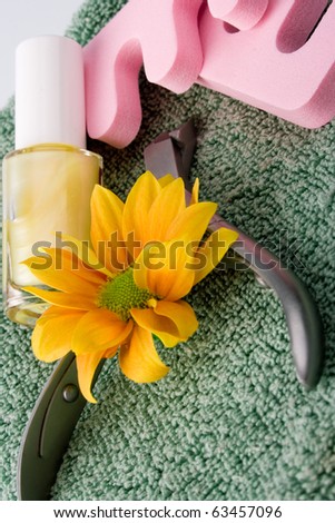 pedicure beauty set and flower on towel background