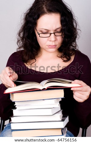 portrait of attractive woman with stack of books