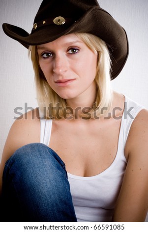 pretty western woman in cowboy shirt and hat isolated on white background