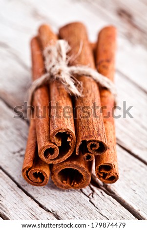 stack of cinnamon sticks on rustic wooden background