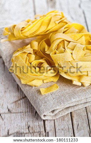 raw egg pasta closeup on rustic wooden background