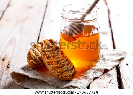 crackers and honey on rustic wooden board
