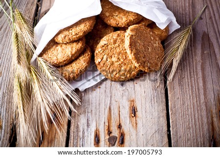 fresh crispy cereal cookies and ears on rustic wooden table