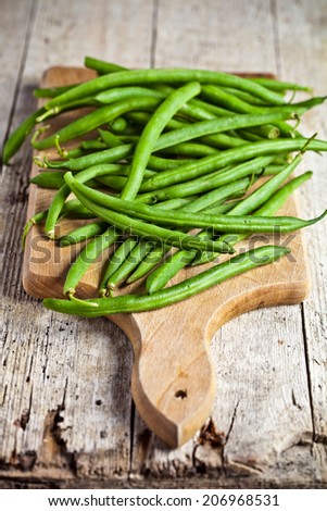 green string beans closeup on wooden board