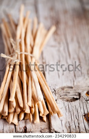 bread sticks grissini torinesi closeup on rustic wooden board