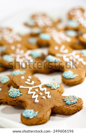 closeup of fresh baked gingerbread men cookies with decorations
