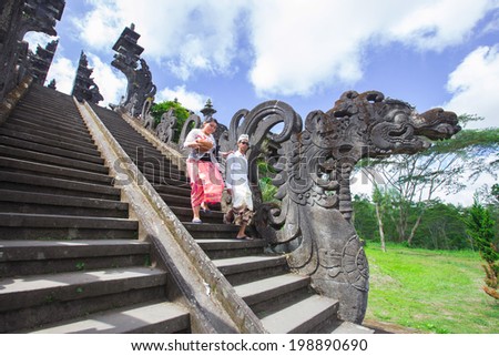 BALI, INDONESIA, May 30: Couple go down after praying in Besakih temple on May 30, 2014 in Bali, Indonesia. Besakih temple is one of the most famous hindu temple in Bali island