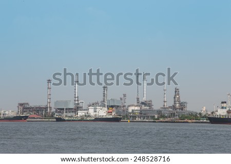 Oil refinery plant with blue sky and ship oil background