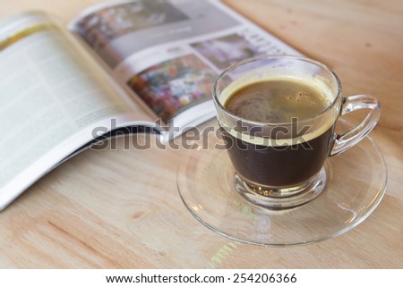 Coffee cup with book on table