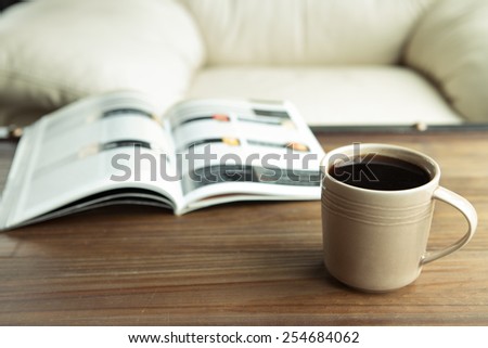 Coffee cup with a book in coffee shop