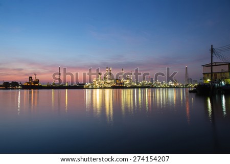 Refinery oil with river at twilight in morning