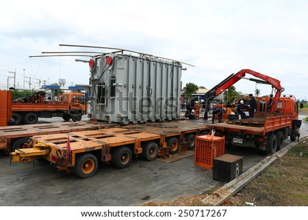 AYUTTHAYA -THAILAND - JANUARY 8 : The workers transported a large old transformer at Gas station, January 8, 2014 in Ayutthaya province, Thailand