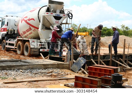 SARABURI -THAILAND - JUNE 10 : Construction site : builder worker with tube from truck mounted concrete pump pouring cement into formwork reinforcement, June 10, 2015 in Saraburi province, Thailand