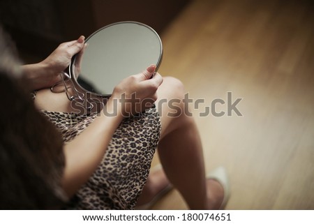 Girl holding a mirror in her hand