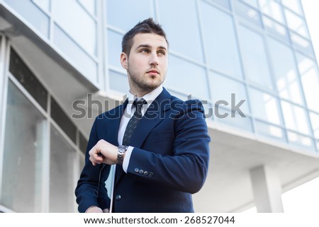 Proud Businessman look at time in front of his office