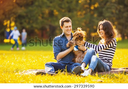 Lifestyle, happy family of two resting at a picnic in the park with a dog
