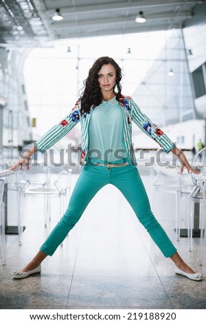 Woman in casual clothes style posing at the airport cafe.