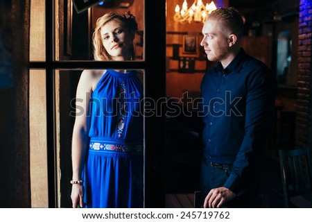 Couple photo in the daylight through the window. Contrast photo with shadows. Man and woman posing.