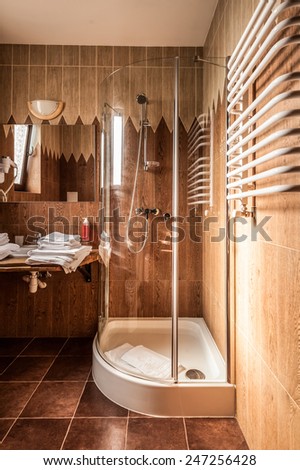 Interior of a modern bathroom. Shower cabin, basins. The vertical position photo.