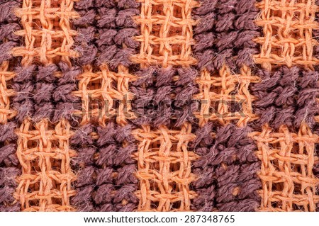 Surface of colorful cross-stitch pattern textile  in macro style. For the background.