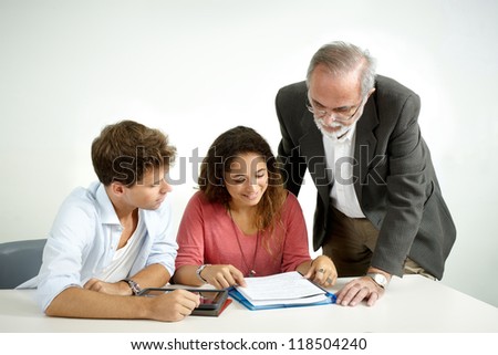 Teacher giving instructions to a couple of students