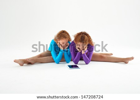 Twin sisters with digital tablet