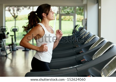 Young Woman Running On Treadmill