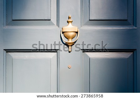 Background of vintage blue painted door and knocker vignette look