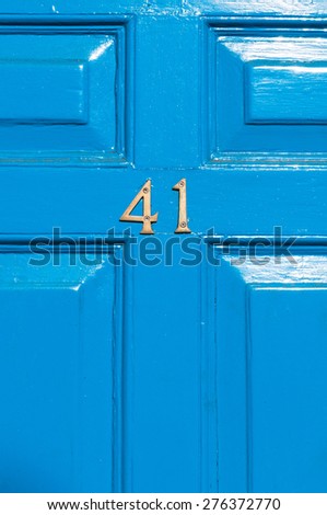 Door number 41 reflective blue door close up