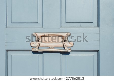 Closeup of letter box in a wooden door close up