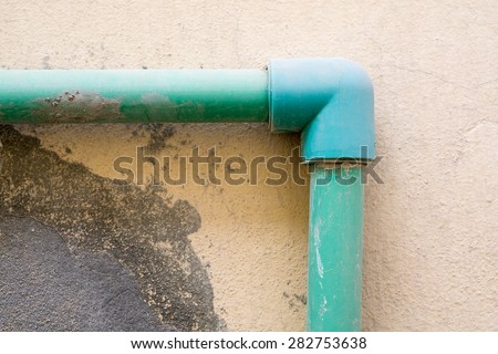 Water pipe connected with elbow to other pipes closeup