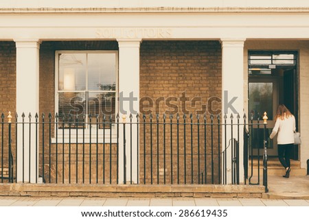 Woman walking into a Solicitors office closeup