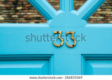 Door number 33 thirty three conceptual image closeup