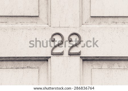 Door number 22 twenty two  conceptual monochrome image closeup