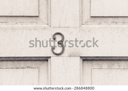 Door number 3 three  conceptual monochrome image  closeup
