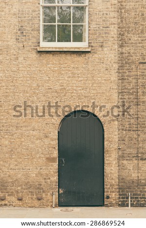 Vintage arched wooden door entrance of a terraced house, England