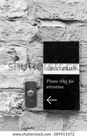 'Deliveries' 'Please ring for attention'  bell and sign on an old wall conceptual image