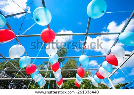 Blue, red and white balloons in the sunshine
