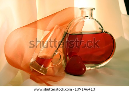 Heart shaped bottle filled with red liquid