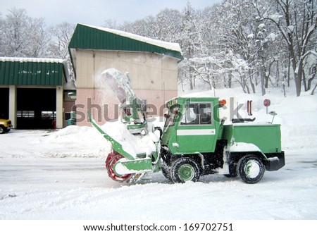green snow truck on snowy road