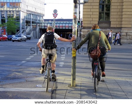 Munich, Germany - July 2014- urban biker, biking to work at the red light