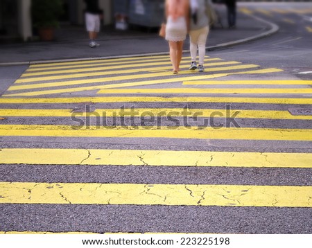 abstract pedestrians street crossing on yellow zebra line